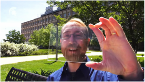 Picture of a man holding a slice of window to use for solar harvesting