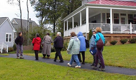 People walking up a path for a cohousing community tour