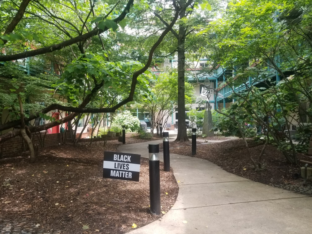 walkway with a sign that reads "Black Lives Matter"