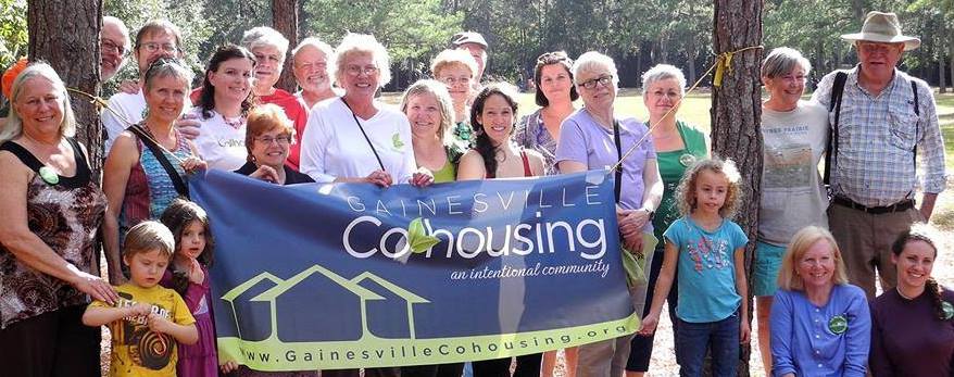 Gainesville Cohousing Community group photo holding a banner