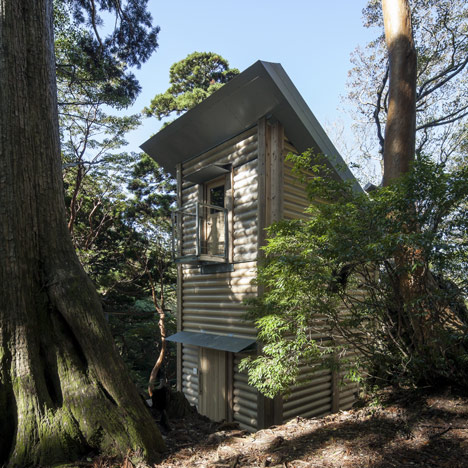 Picture of a cardboard house with trees surrounding it