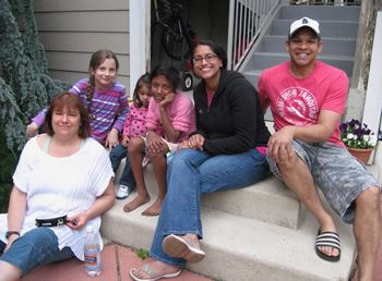 People and kids sitting on a front porch
