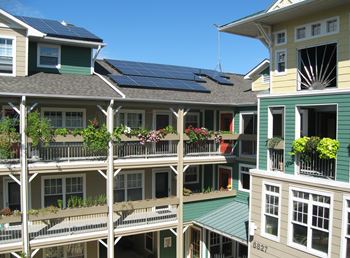 Rooftop view of Takoma Village Cohousing apartments with solar panels on top